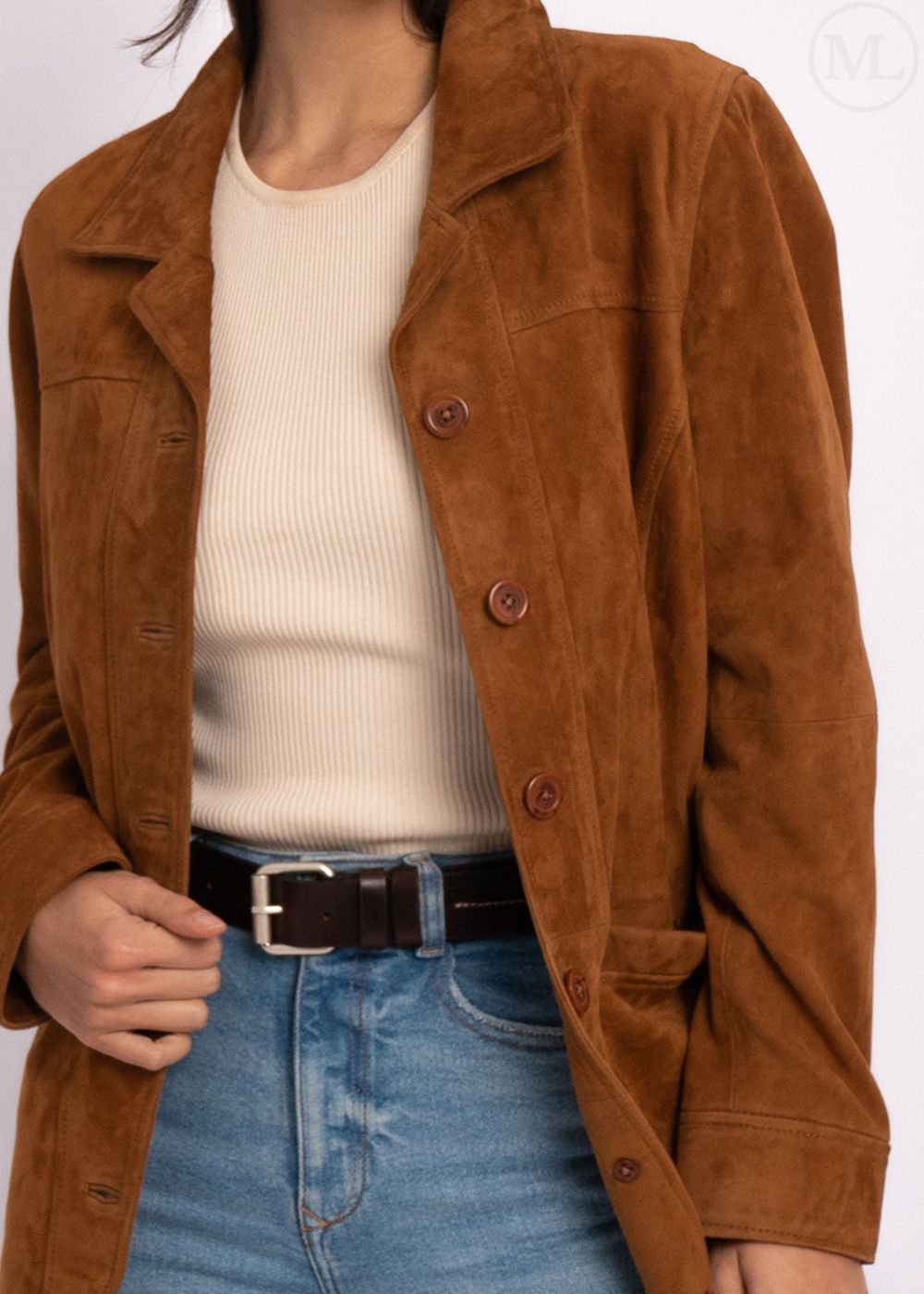 Cognac Brown suede leather coat worn over a cream sweater and blue jeans on a white background