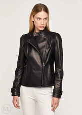 Woman wearing a black leather biker jacket on a white background