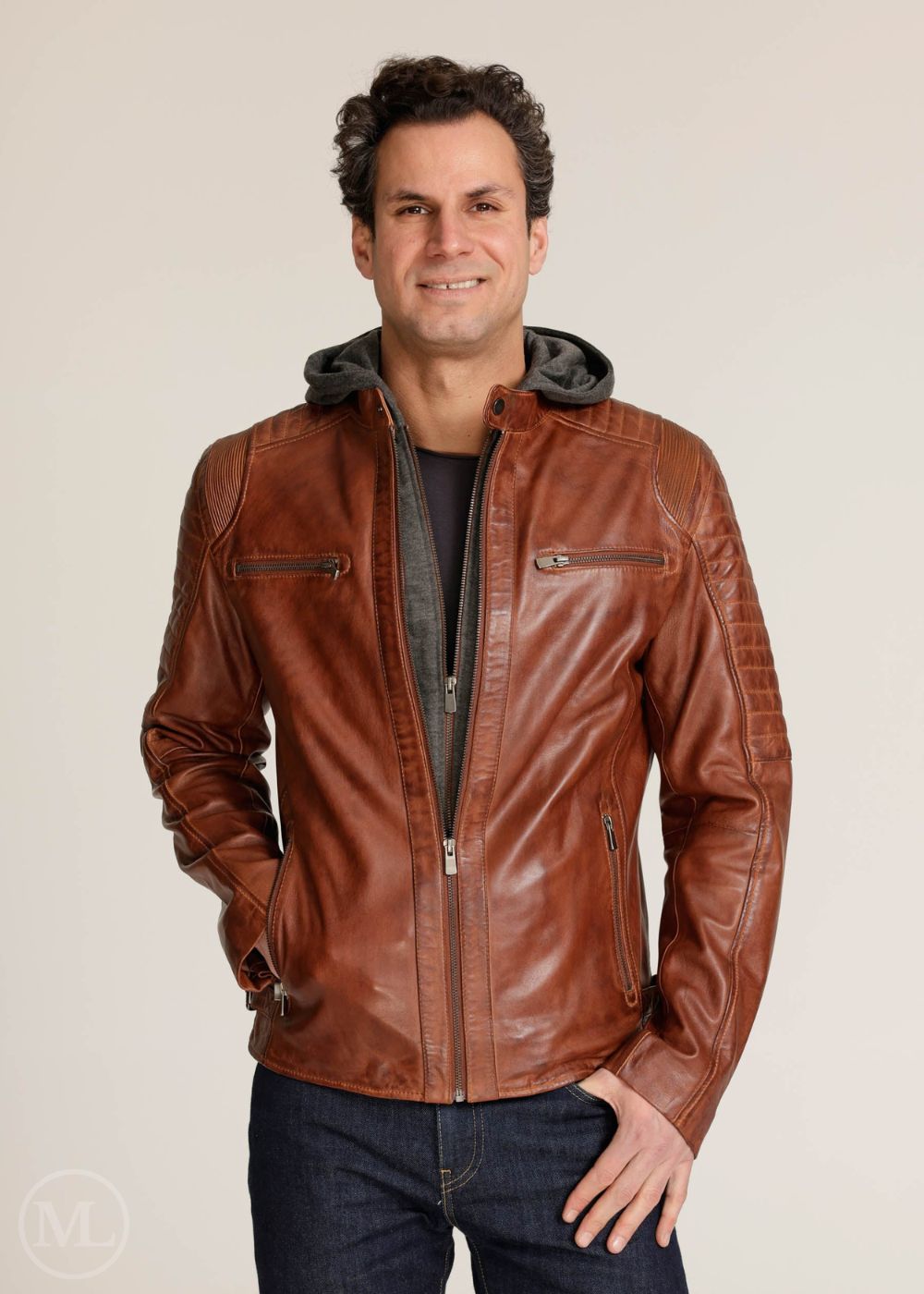 Man wearing a brown leather Motorcycle jacket with a hood on a plain background