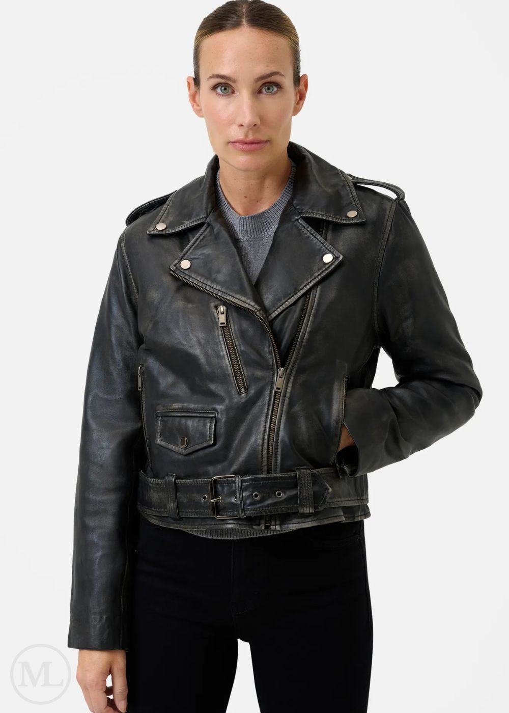 Woman wearing a black leather biker jacket on a white background
