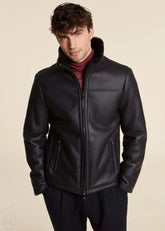 Man wearing a dark blue leather jacket on a beige background