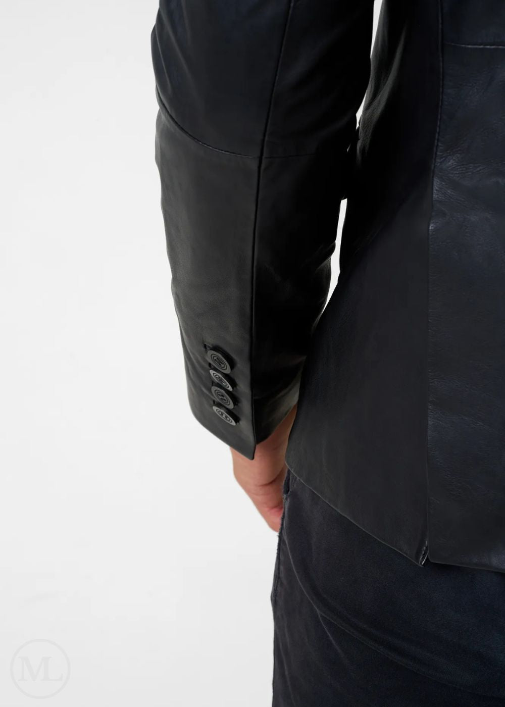 Close-up of a black leather blazer jacket with a white background