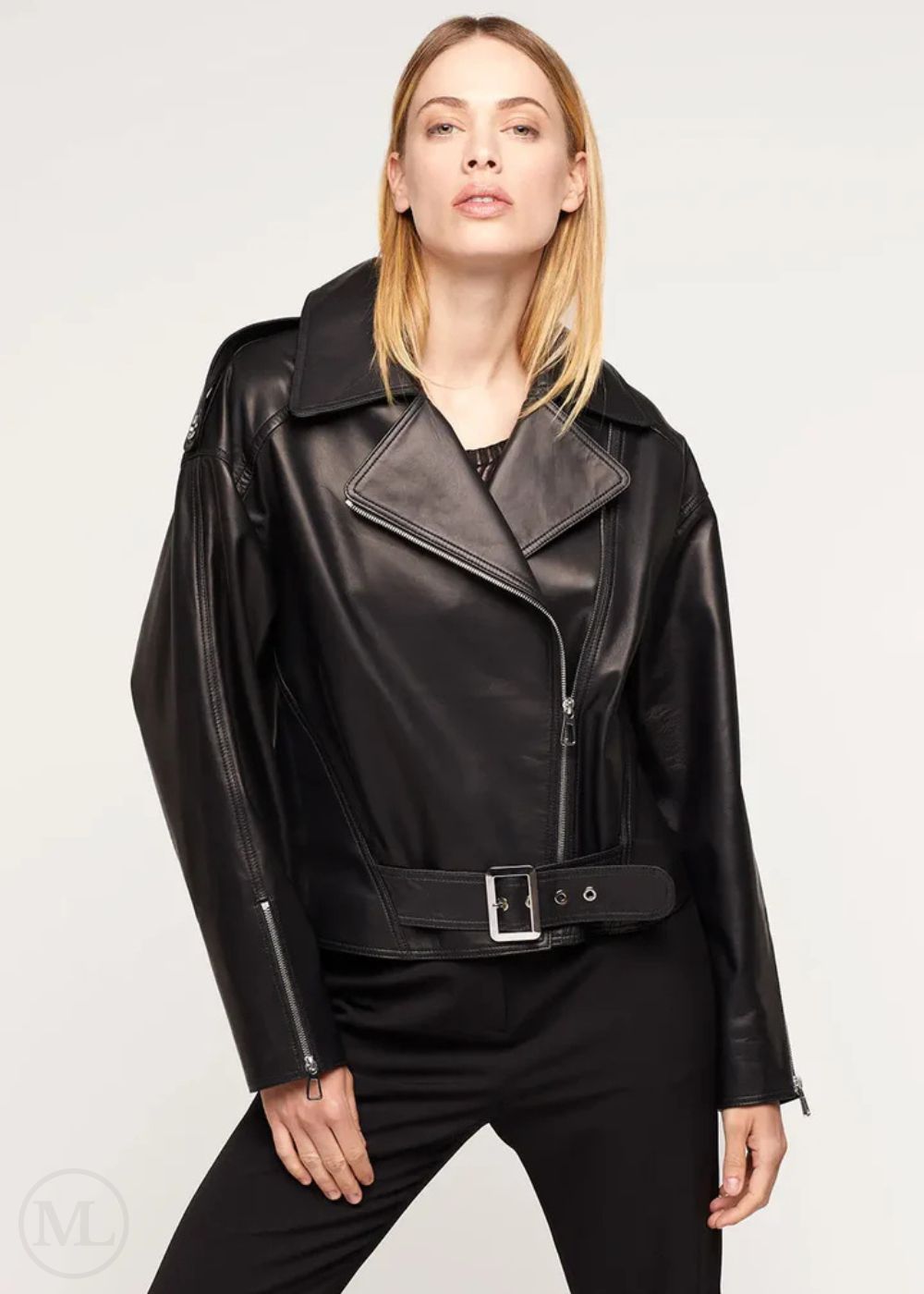 Woman wearing a black leather biker jacket on a white background