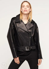 Woman wearing a black leather biker jacket on a white background