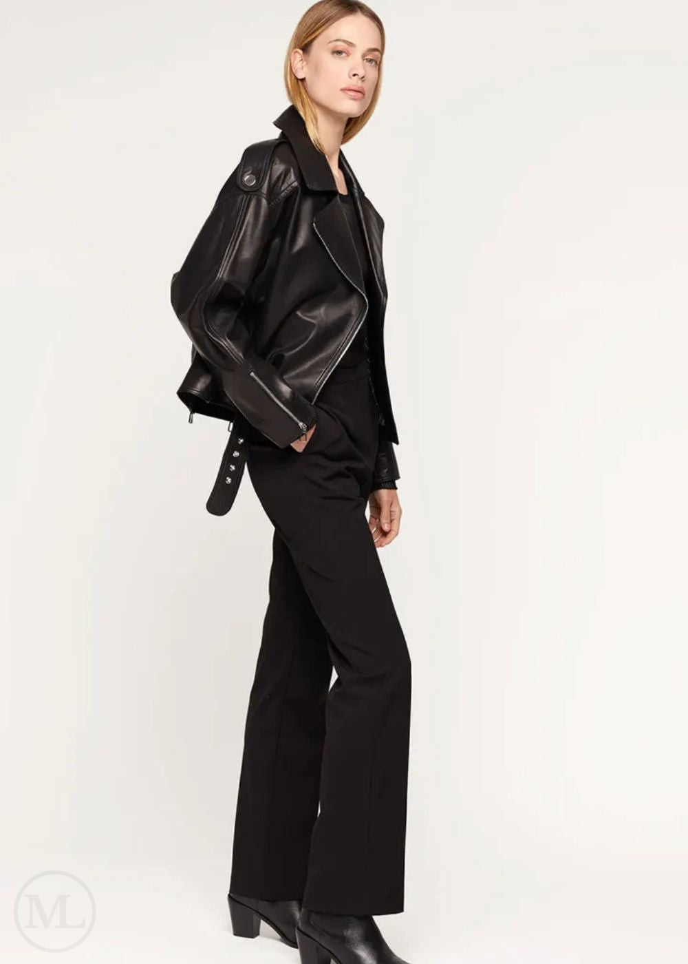 Women wearing a black leather biker jacket and pants on a white background