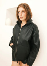 Women wearing a black Hoodie jacket against a white background