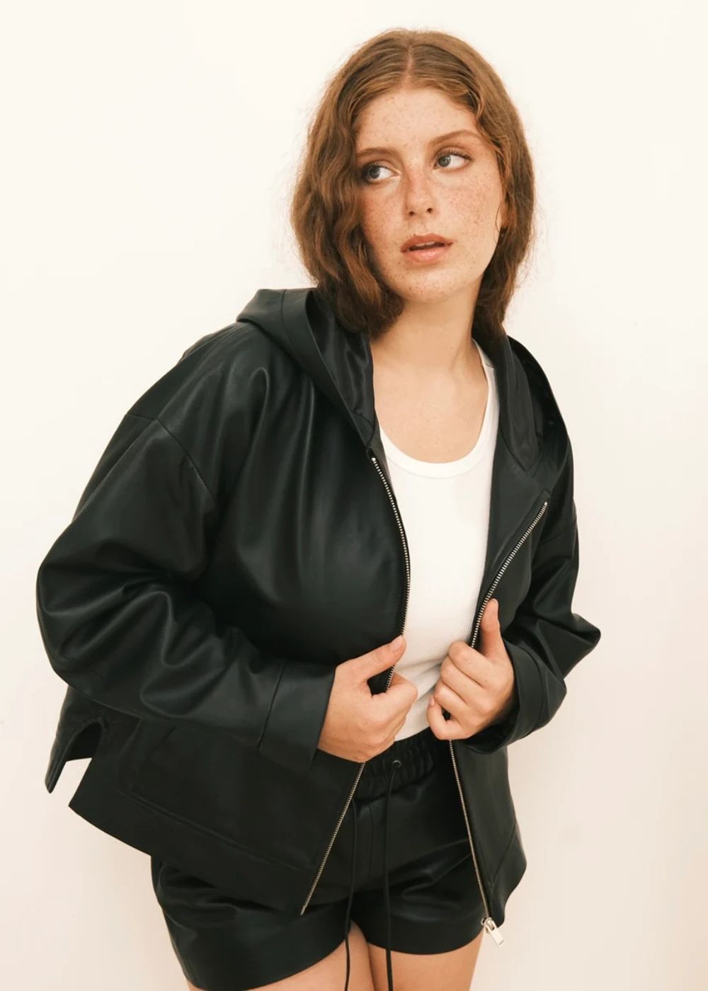 Women wearing a black Hoodie jacket against a white background