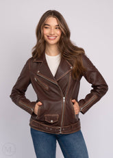 Woman wearing a dark brown leather biker jacket on a plain background