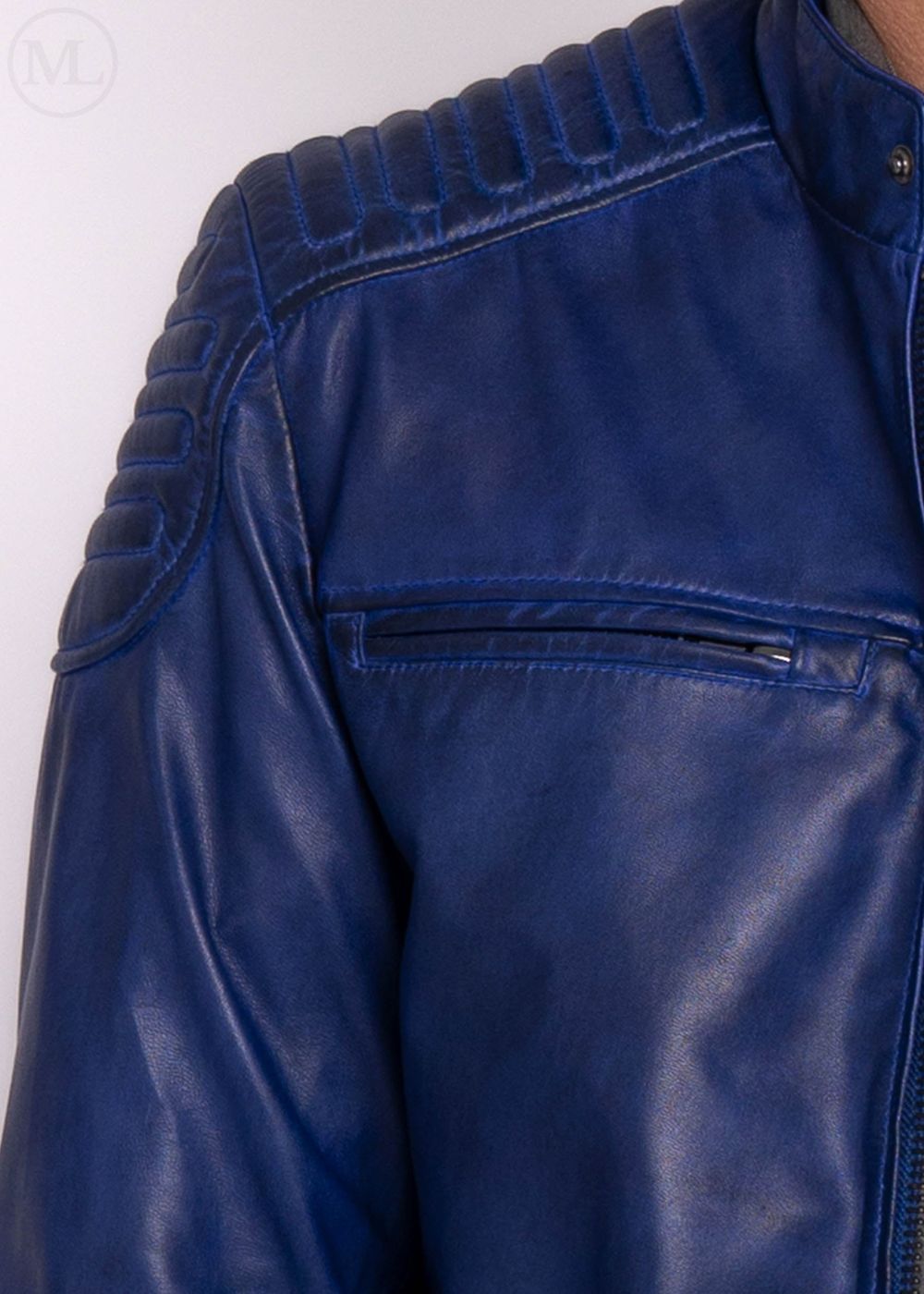 Close-up of a blue leather jacket worn by a man with a white background