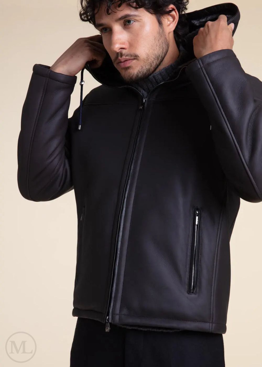 Man wearing a Dark Grey Hooded Shearling leather jacket against a beige background