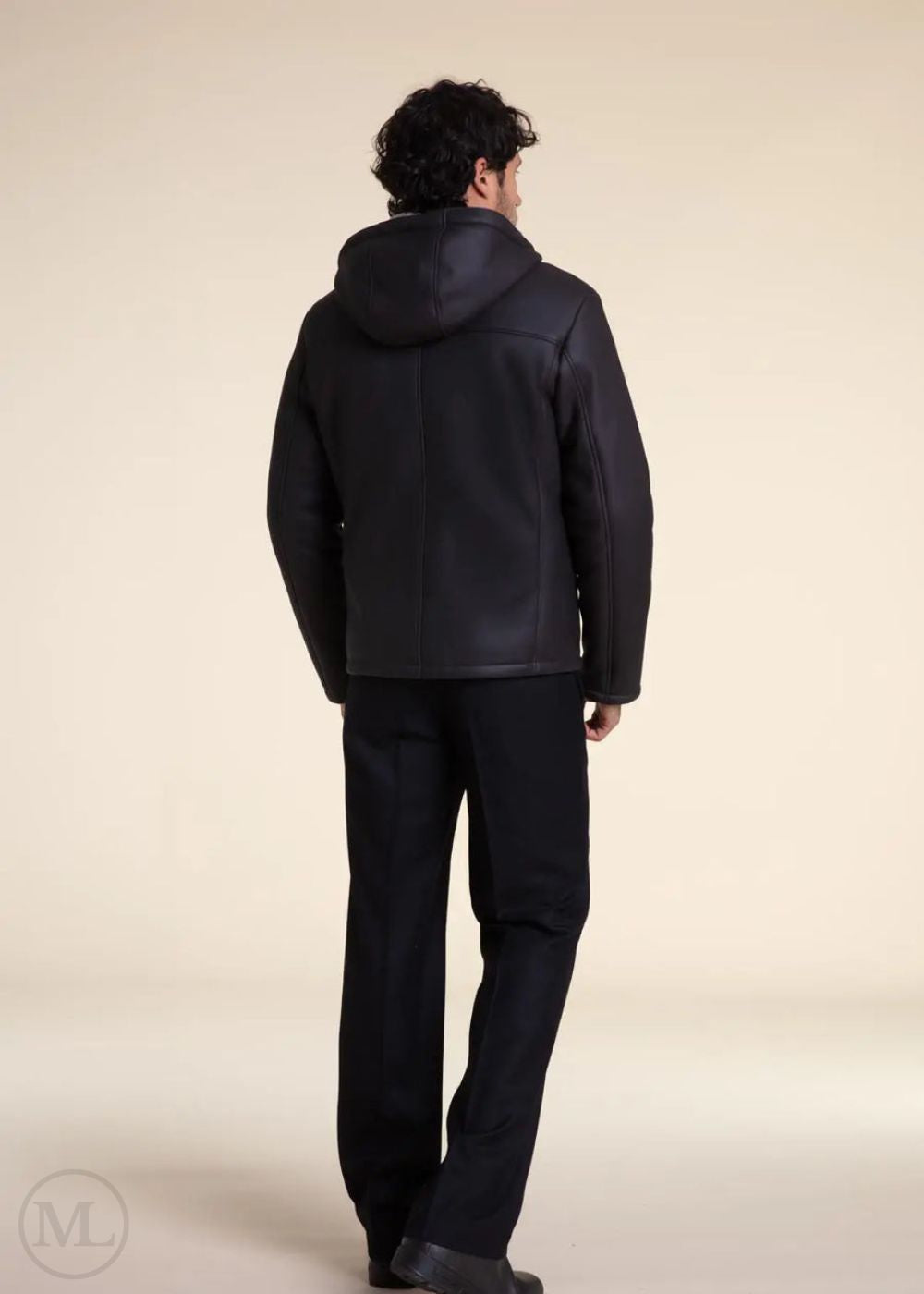 Man wearing a Dark Grey Hooded Shearling leather jacket and pants on a beige background