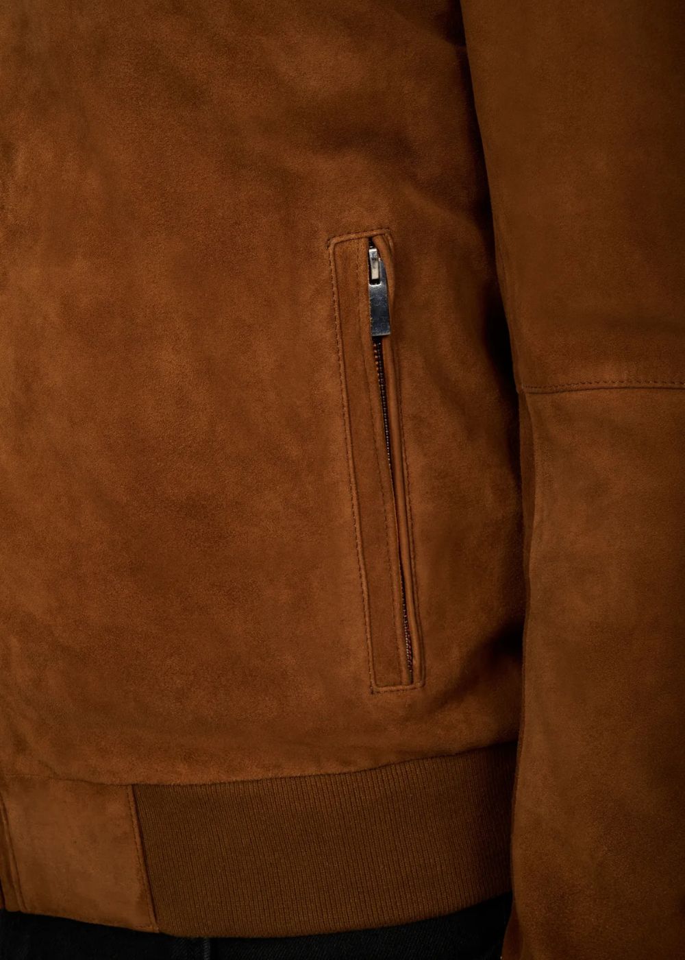 Brown suede bomber jacket zip closeup