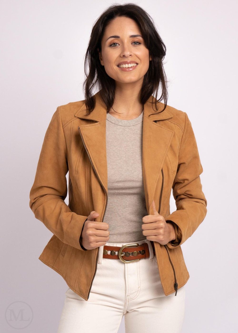 Woman wearing a camel leather jacket on a white background