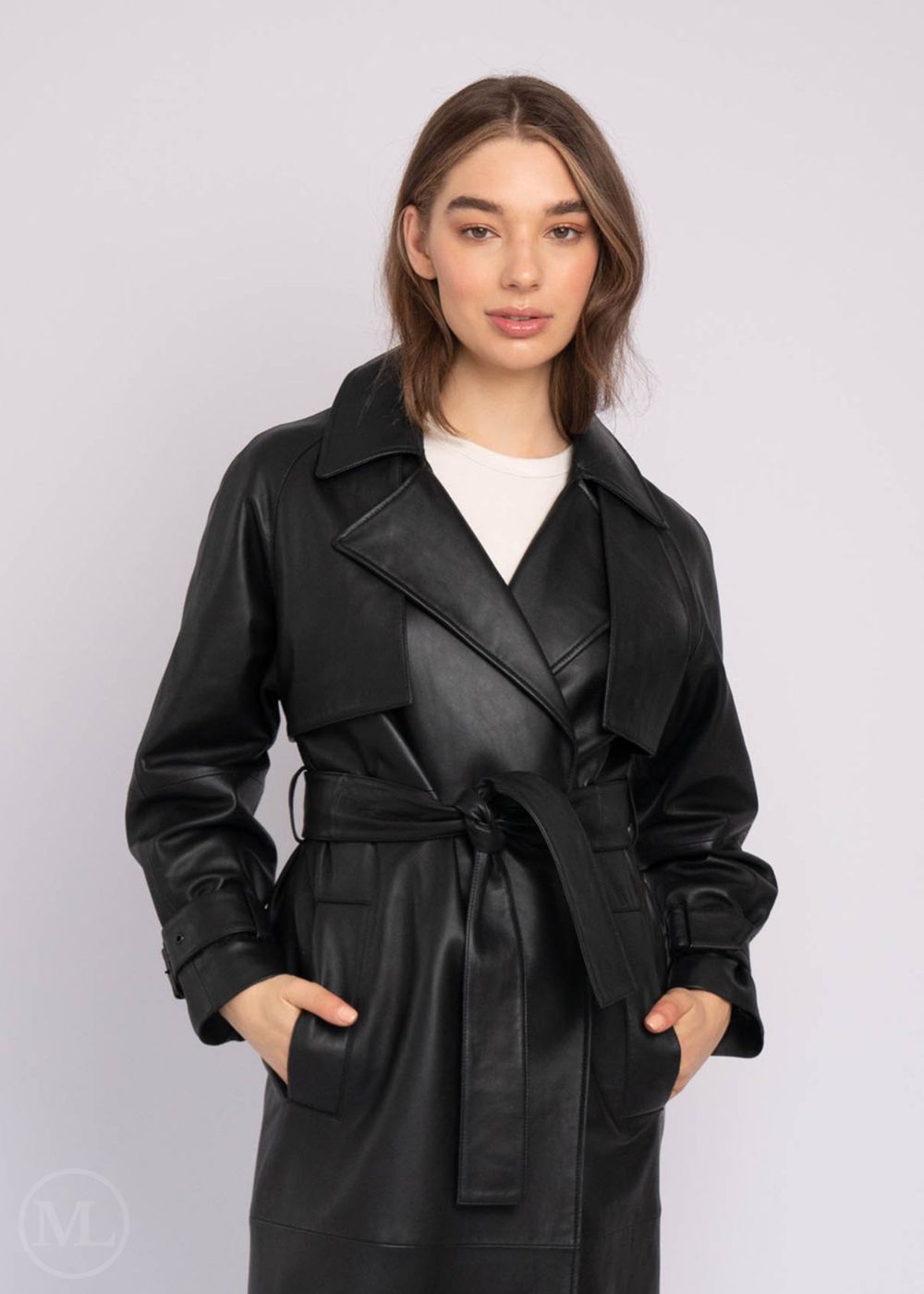 Woman wearing a black leather coat against a white background