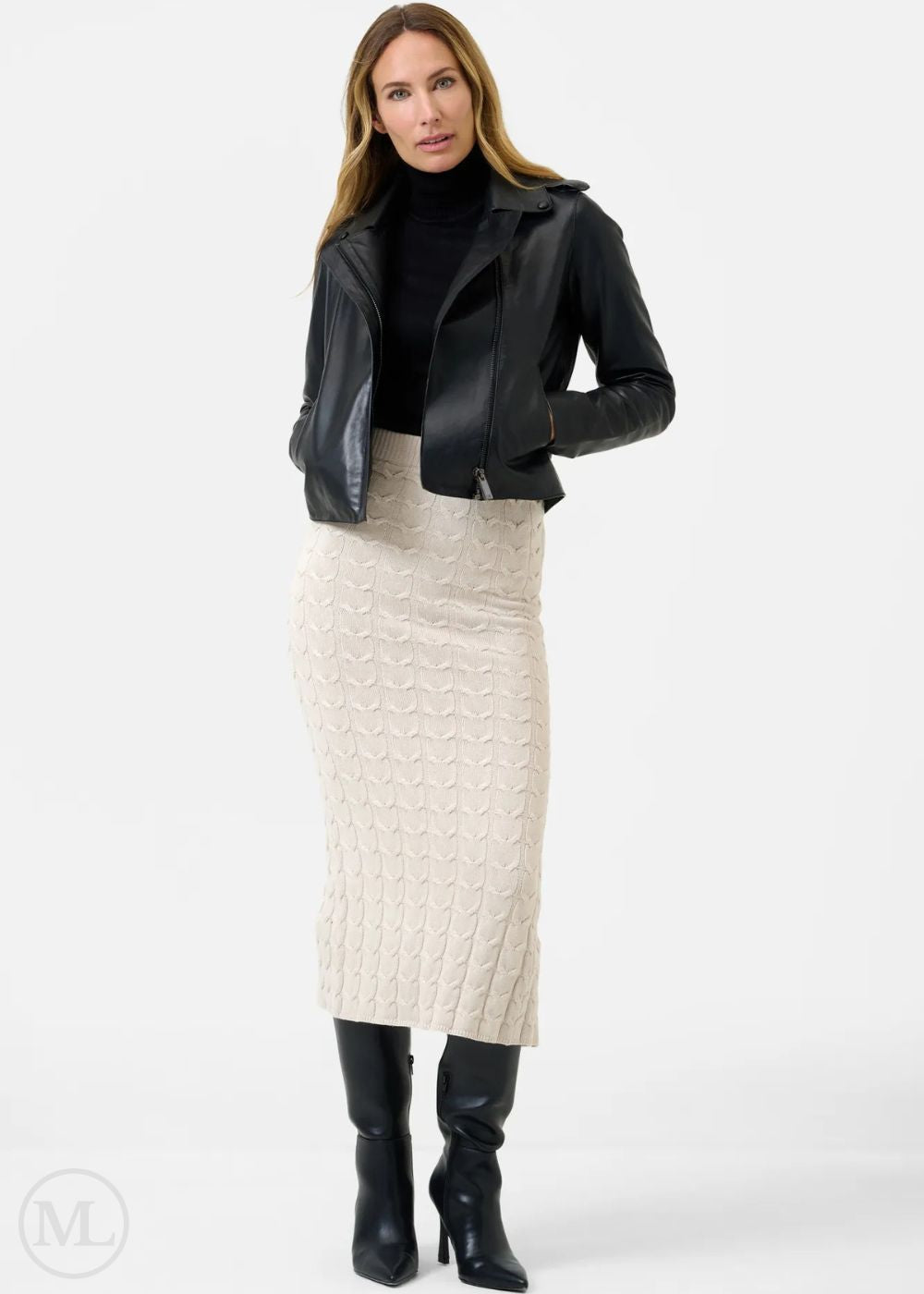 Woman wearing a black leather jacket, black top, and cream skirt on a white background