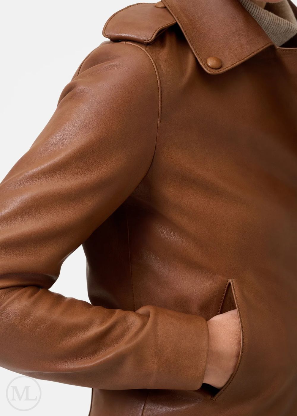 Close-up of a brown leather jacket with a visible brand logo.