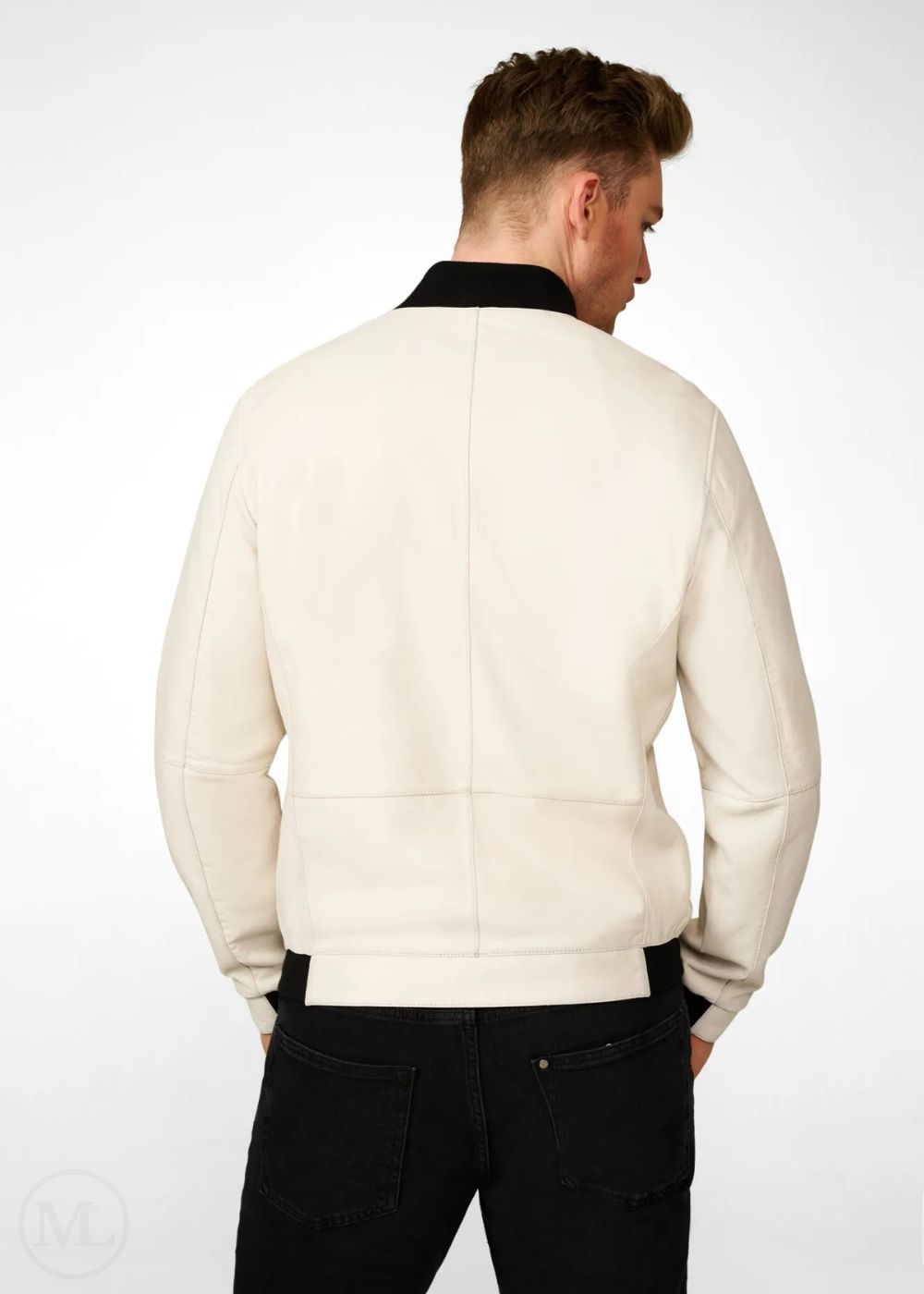 Man wearing a white leather bomber jacket and black pants on a white background