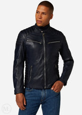 Man wearing a Navy Blue leather biker jacket and blue jeans on a white background
