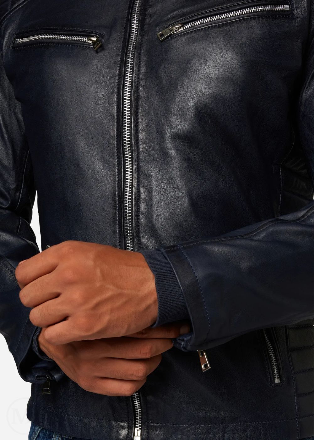 Close-up of a Navy blue leather jacket with a zipper, showing a hand holding the sleeve.