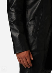 Close-up of a black leather trench coat worn by a man on a white background