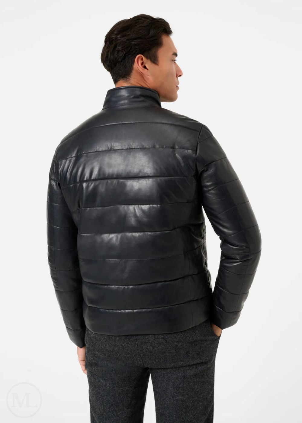 Man wearing a black leather puffer jacket on a white background