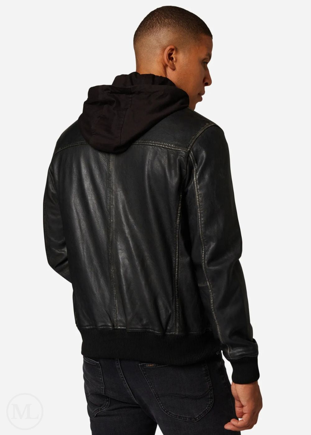 Man wearing a black leather hooded bomber jacket on a plain background