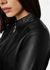 Close-up of a woman wearing a black leather jacket on a white background