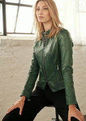 Woman wearing a green leather jacket in an indoor setting