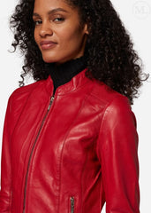 Woman wearing a red leather jacket on a white background