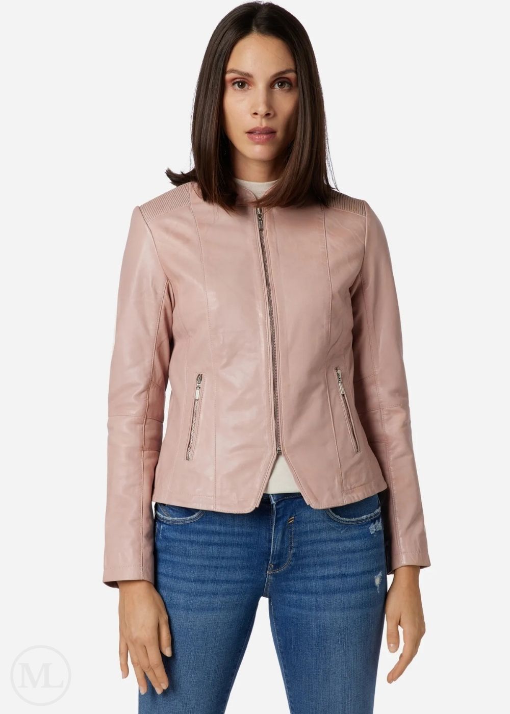 Woman wearing a rose gold leather jacket and blue jeans on a white background