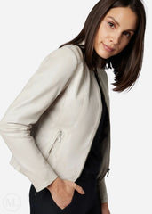 Woman wearing a white leather jacket on a white background