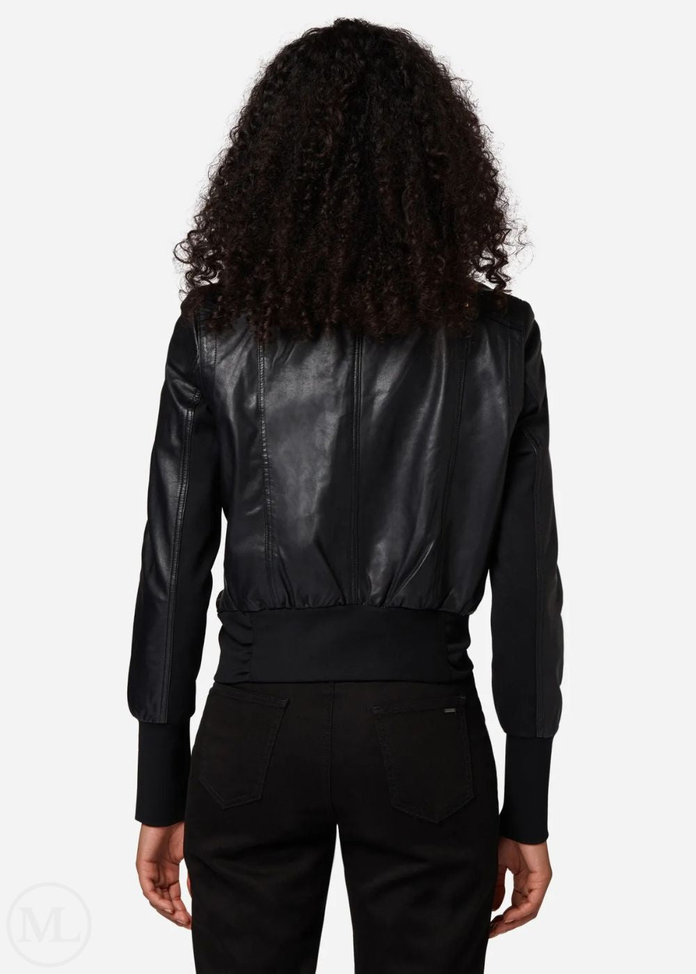 Woman wearing a black leather bomber jacket from behind on a white background