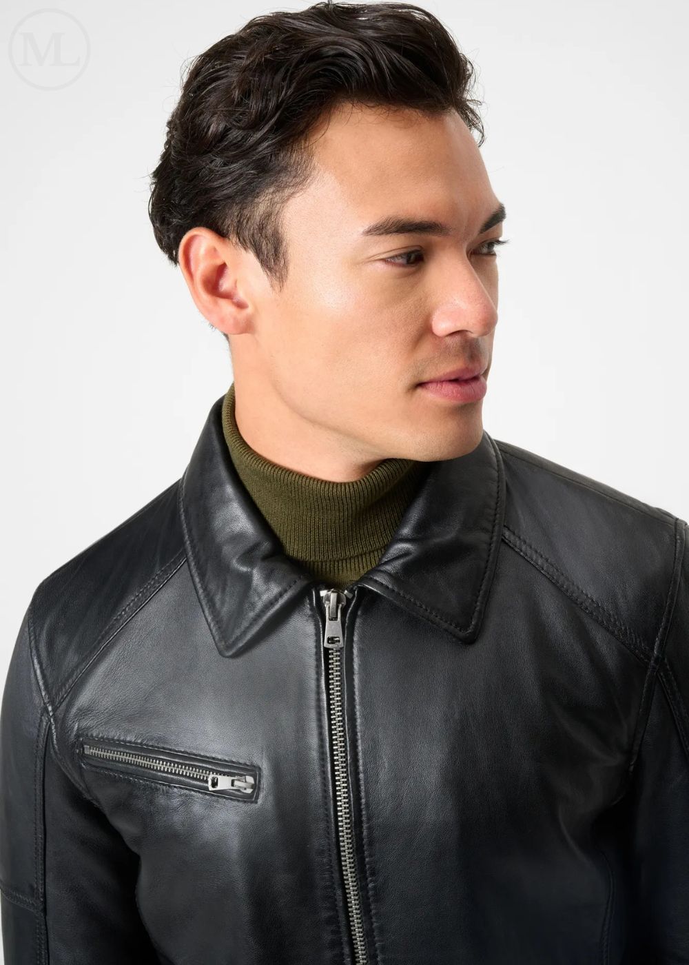 Man wearing a black leather racer jacket with a plain background