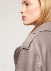 Close-up of a woman wearing a gray Oversized Nubuck Leather Biker Jacket with Belted Waist with a light gray background