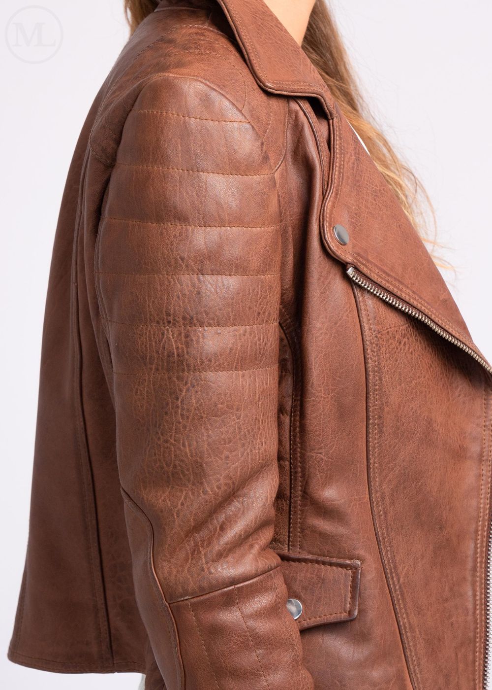 Cognac Brown leather jacket worn by a woman with a white background