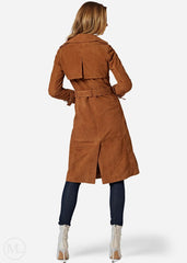 Woman wearing a brown suede trench coat on a white background