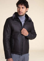 Man wearing a dark grey leather jacket with fur collar on a beige background