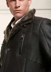 Man wearing a dark brown leather coat with fur collar against a neutral background