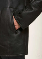 Close-up of a dark brown leather jacket with a zipper on a white background