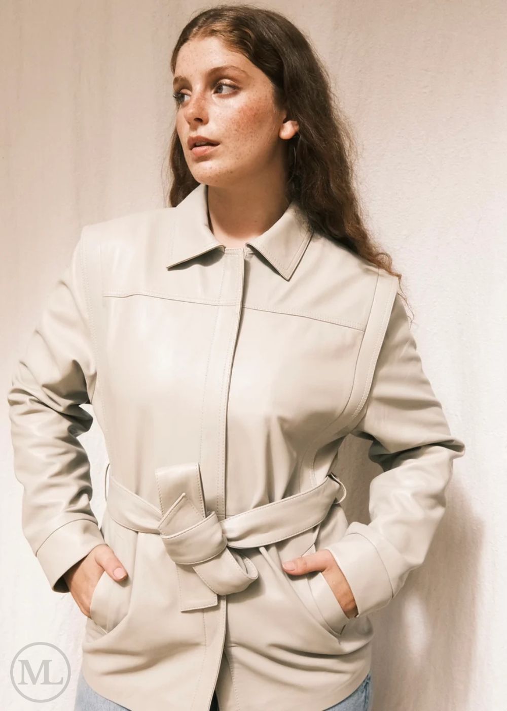 Woman wearing a Lvory Leather coat against a plain background
