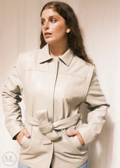 Woman wearing a Lvory Leather coat against a plain background