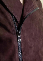 Close-up of a zipper on a dark brown suede jacket