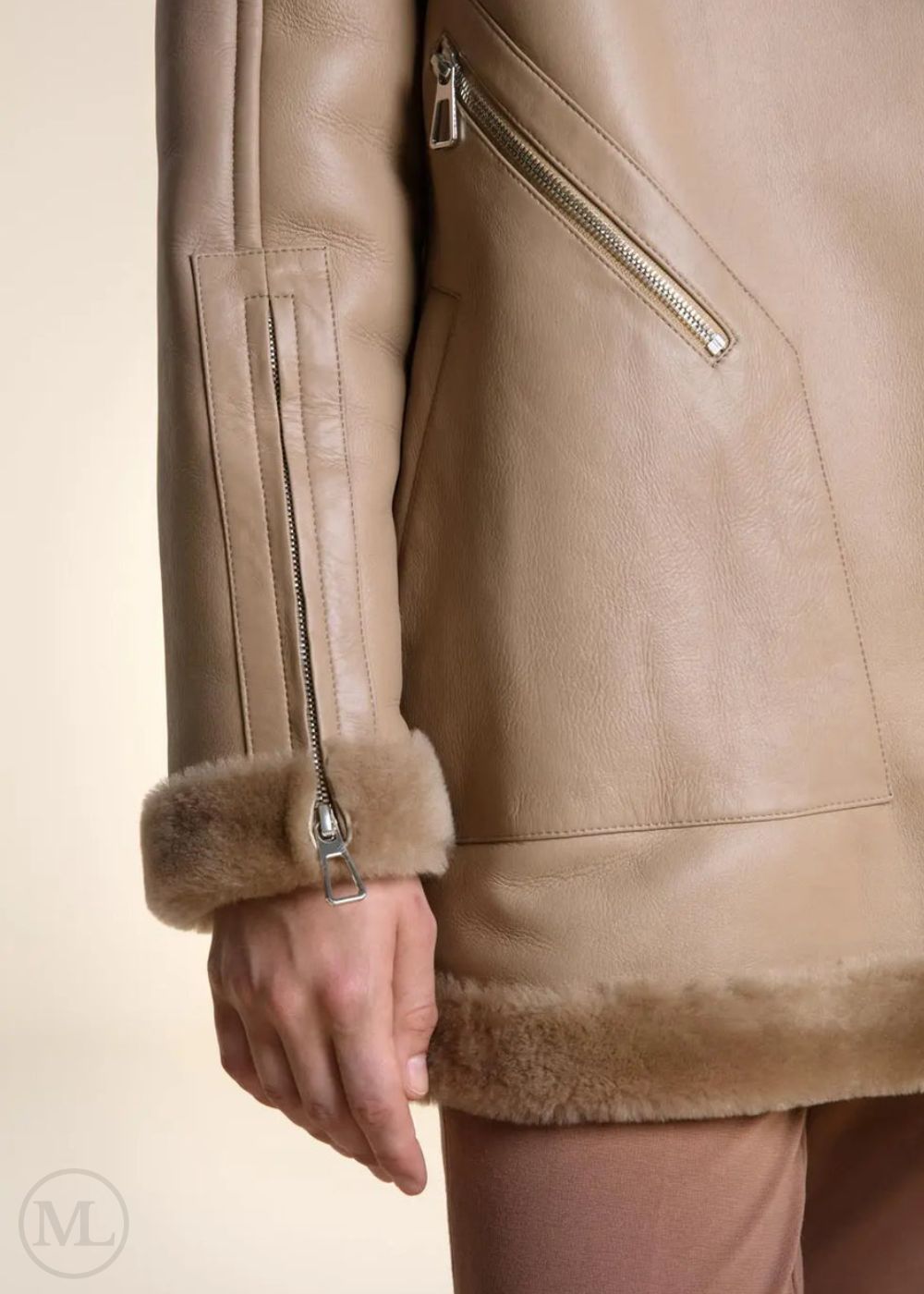 Close-up of a camel  leather coat with fur trim on a neutral background