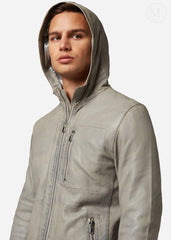 Man wearing a gray leather hooded jacket on a white background