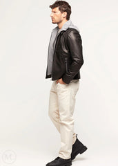 Man wearing a black lambskin leather jacket and white pants on a white background