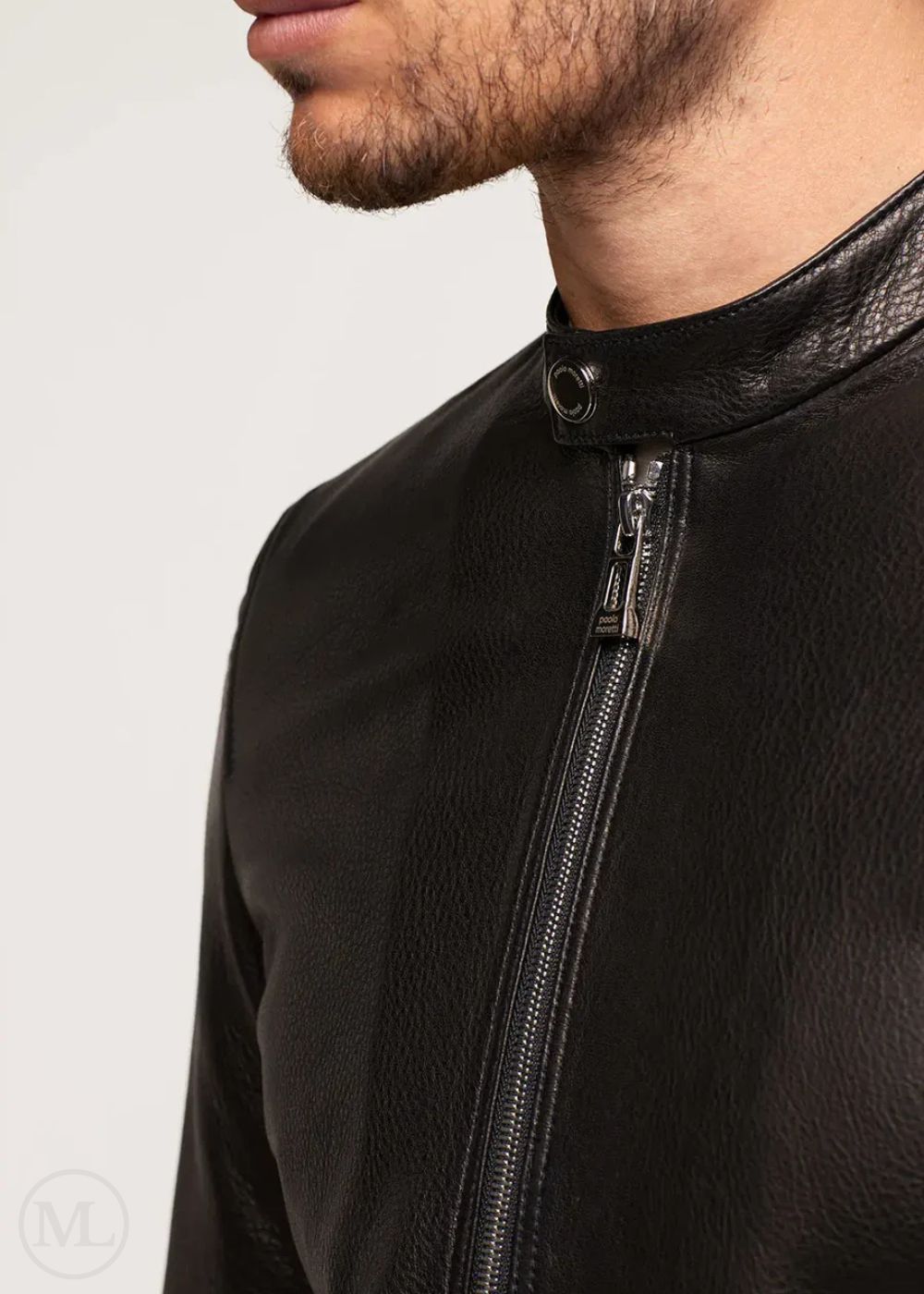 Close-up of a black leather jacket with a zipper on a neutral background