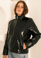 Women wearing a black leather Puffer jacket against a plain background