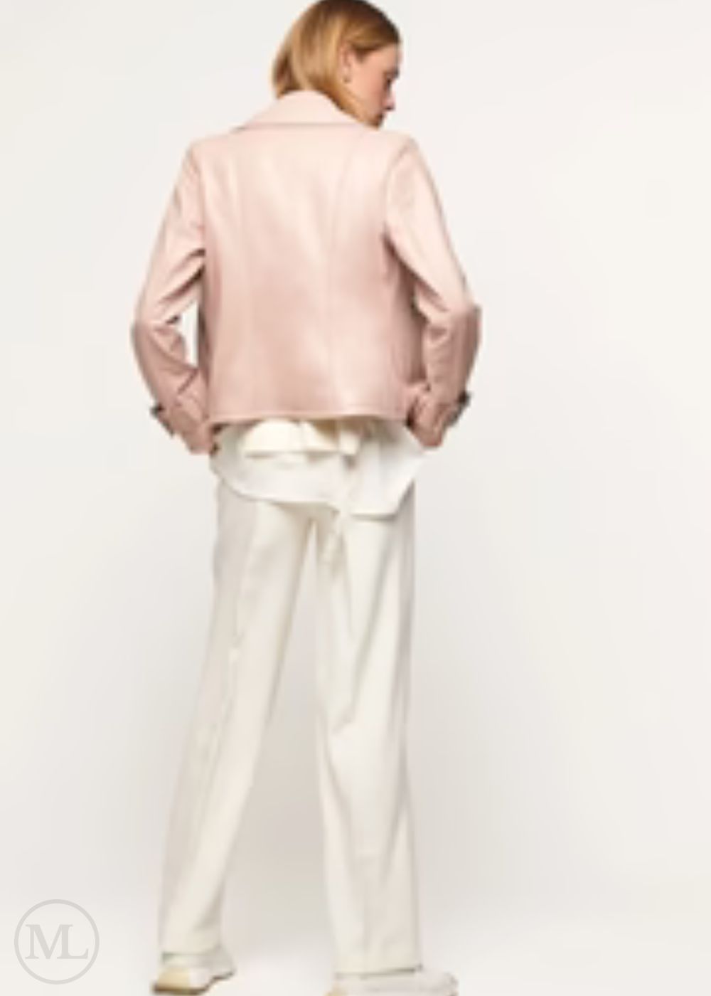 women wearing a fuschia leather biker jacket and white pants on a plain background