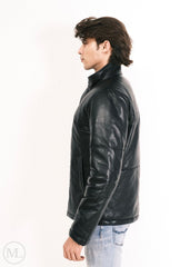 Man wearing a black leather down jacket on a white background, standing sideways