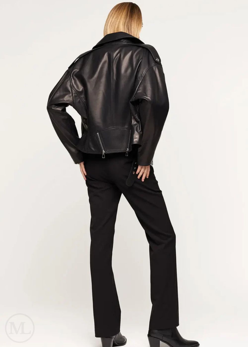 Women wearing a black leather biker jacket and pants on a white background